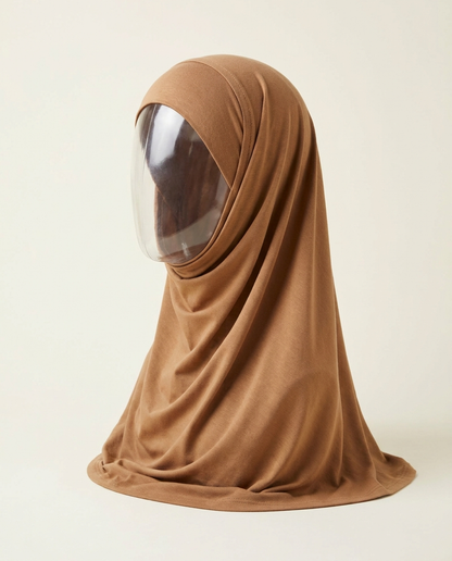 Camel jersey hijab draped over matching underscarf on invisible mannequin, studio shot