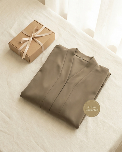 Vaelora khaki plain Dubai abaya folded flat-lay with giftbox and 30-day guarantee badge