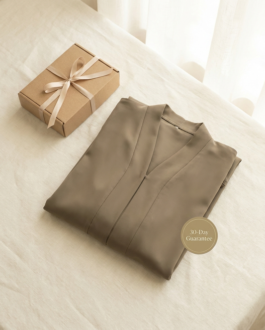 Vaelora khaki plain Dubai abaya folded flat-lay with giftbox and 30-day guarantee badge