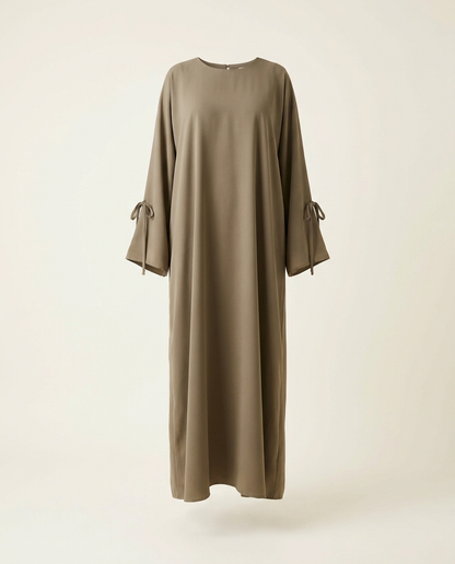 Khaki plain Dubai abaya with loose fit and sleeve ties on invisible mannequin, studio shot
