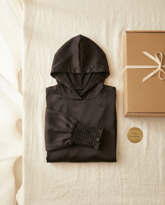 Vaelora black hooded prayer jilbab folded flat-lay with giftbox and 30-day guarantee badge